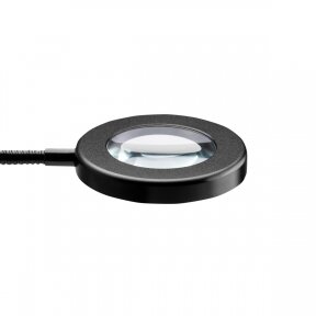 Кольцевой светильник LED SNAKE RING, установленный на столе.